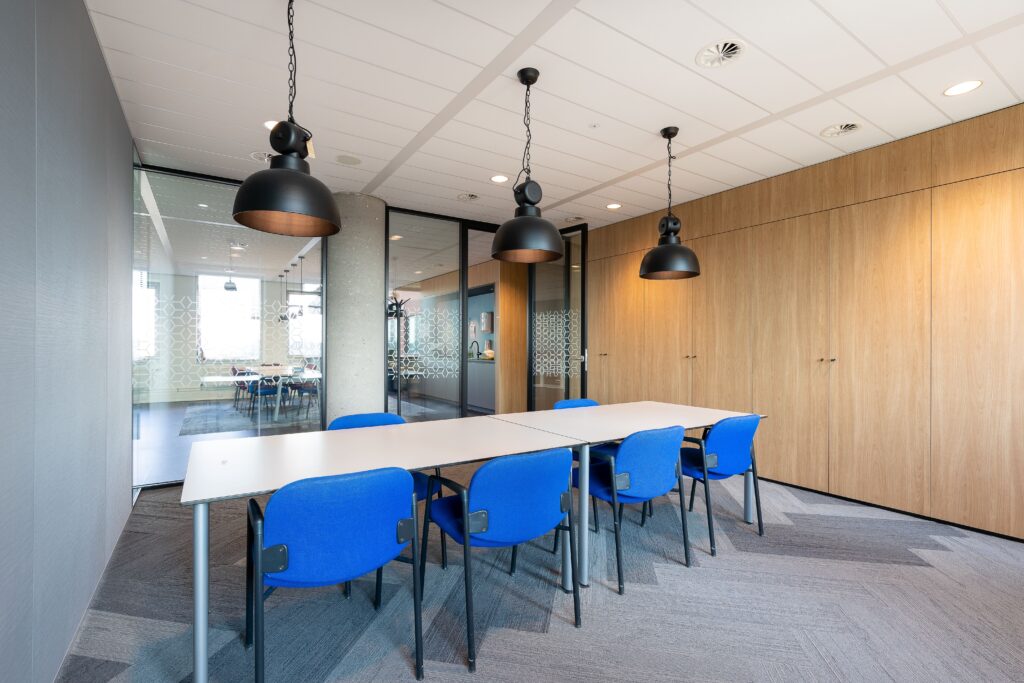 meeting-room-interior-modern-office-with-long-wooden-table-chairs-around-it