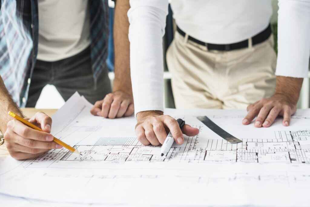 close-up-two-male-architect-s-hand-blueprint